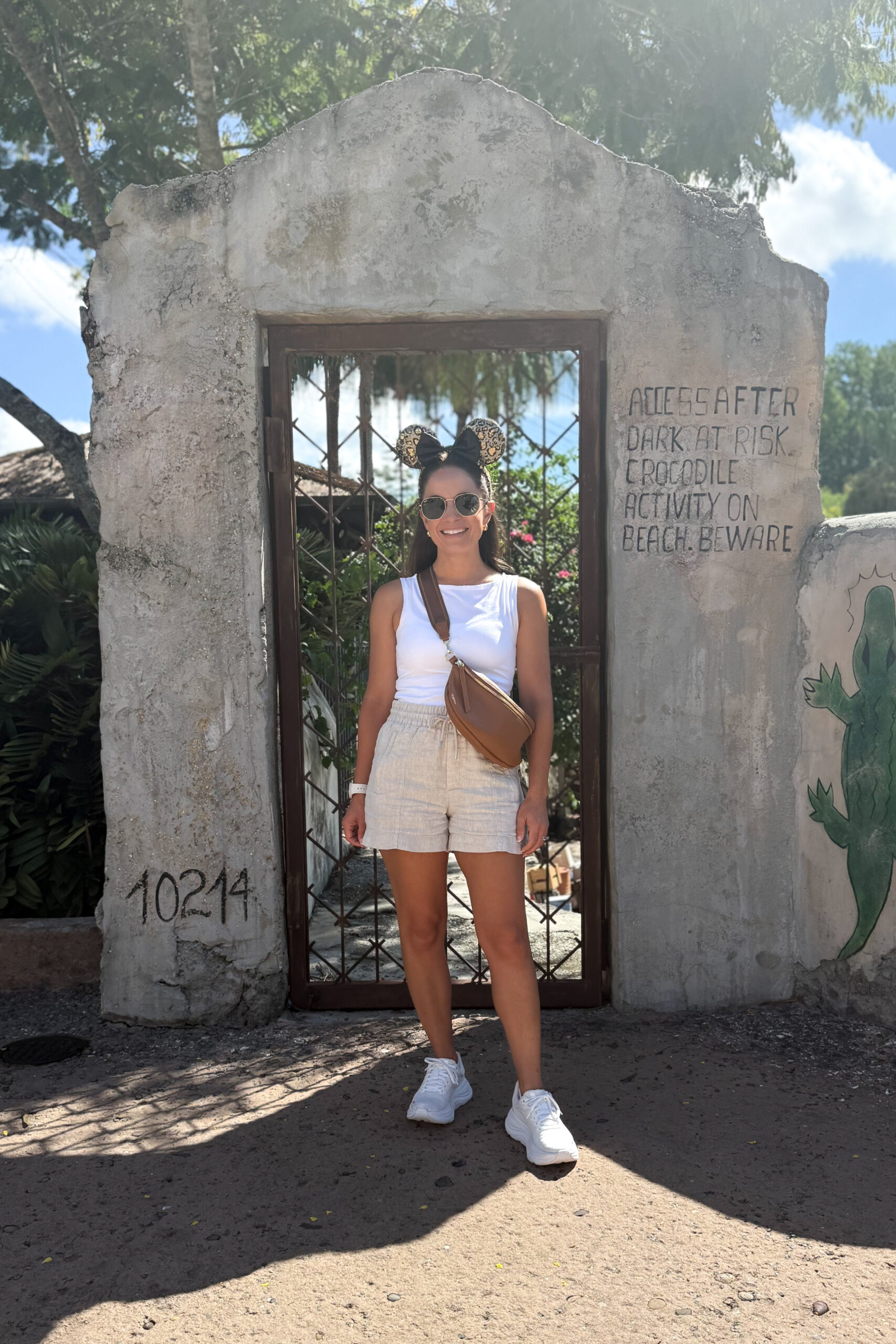 Disney outfit idea for summer! Linen shorts and a cotton white tank top. Styled by petite style blogger Brooke of Pumps and Push-Ups