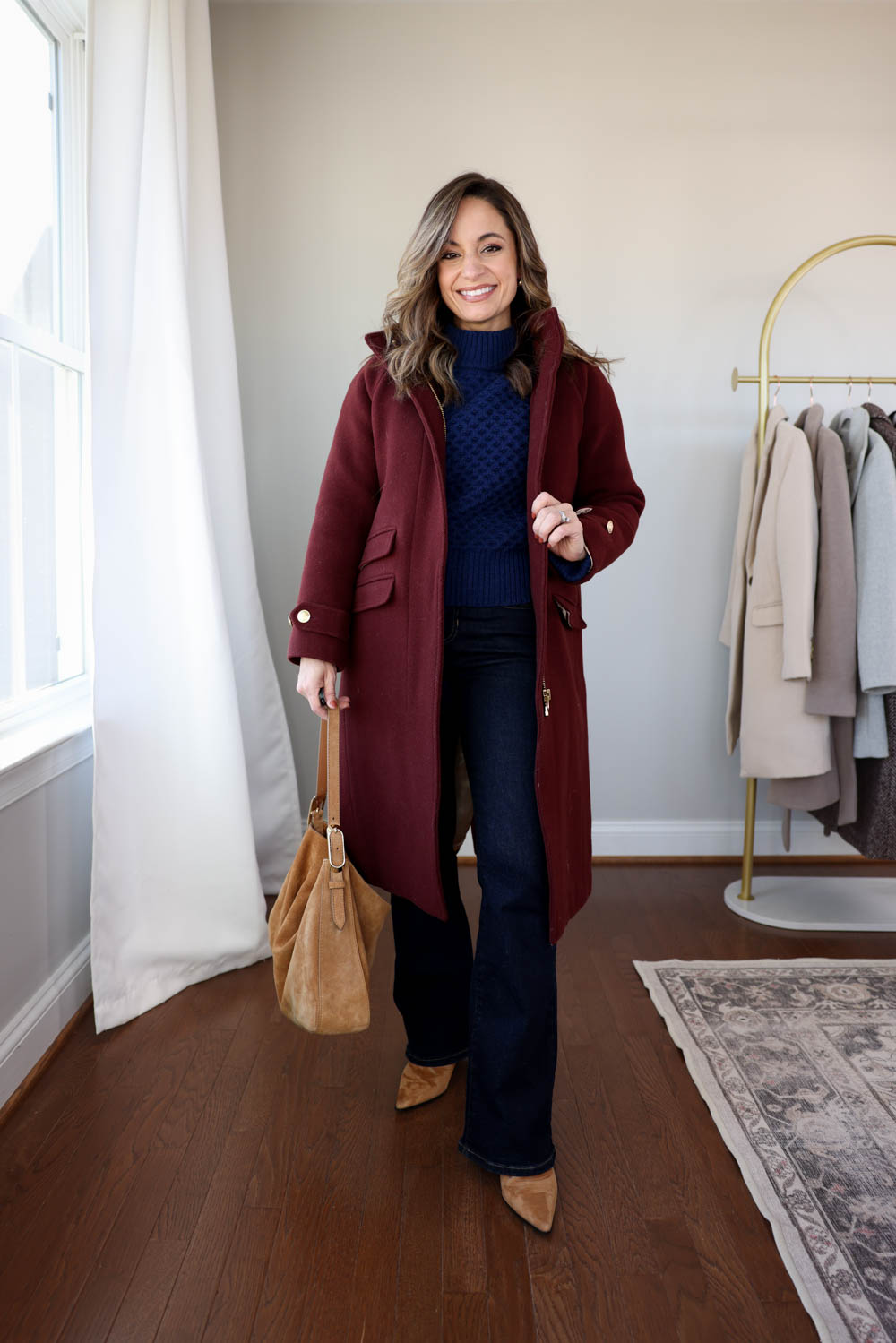 Brooke of Pumps and Push-Ups wearing J.Crew petite bootcut jeans, a honeycomb wool-blend sweater in XXS, and the J.Crew Long Toscana Coat in Petite 00 for a casual winter outfit.